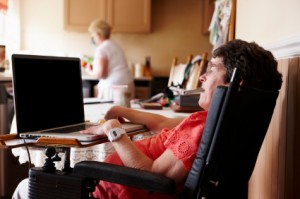 disabled woman working on laptop at home